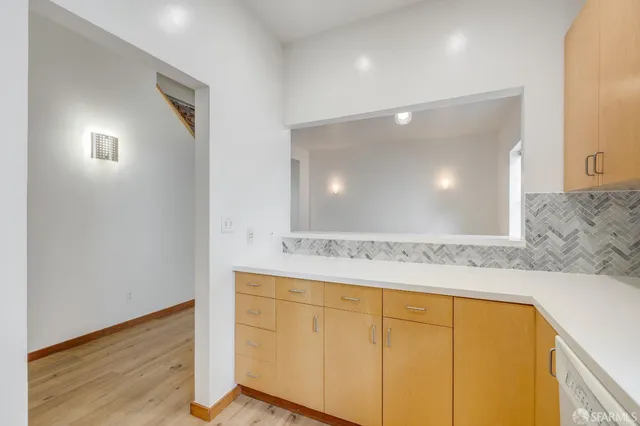 wooden floor in an empty room with a fireplace