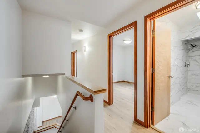 an empty room with wooden floor and a window
