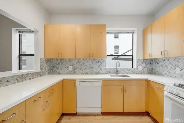 a kitchen with stainless steel appliances granite countertop a sink and cabinets
