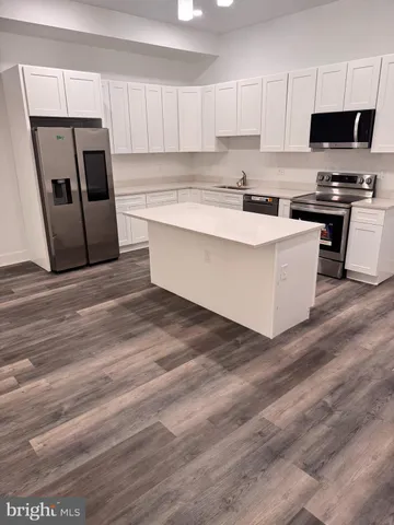 a view of a room with wooden floor