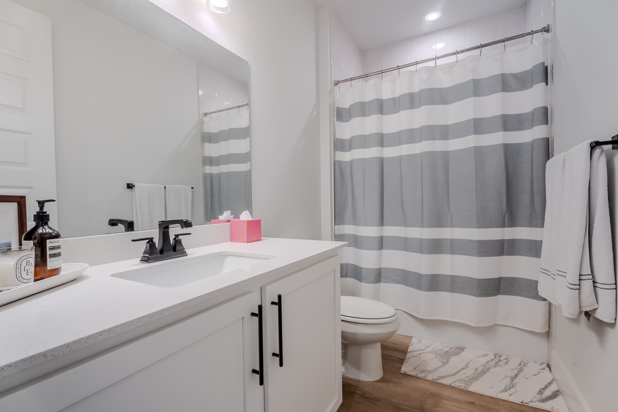 8109 Edmondson Bend Austin, TX 78744 - Photo 5 of 38 A well-appointed bathroom features a single vanity and a shower with a privacy curtain, offering a clean and functional space.