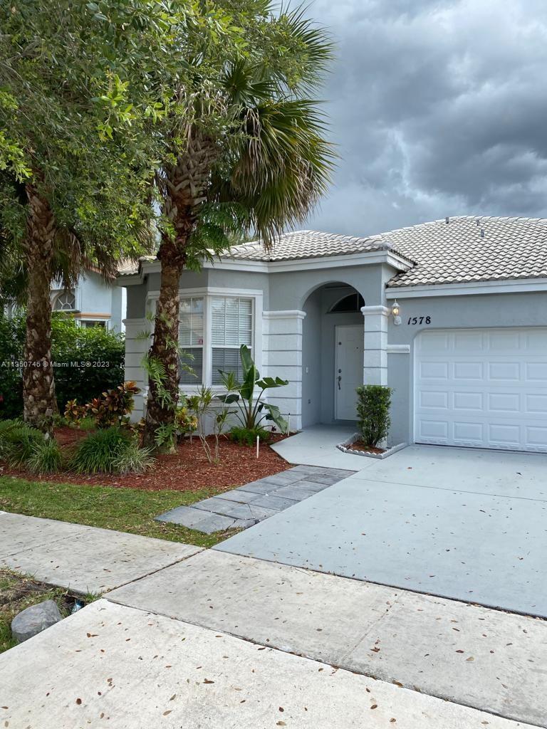Towngate Pembroke Pines, FL 33028 - Photo 3 of 8 a front view of a house with garden and porch