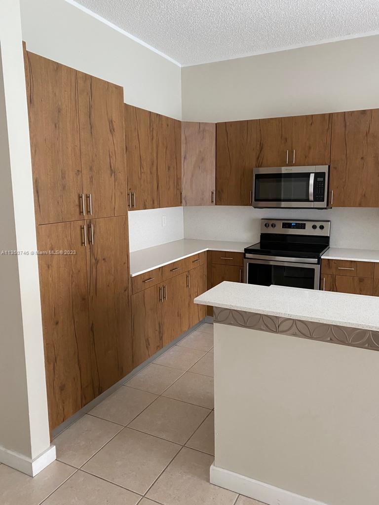 Towngate Pembroke Pines, FL 33028 - Photo 6 of 8 a kitchen with a cabinets and steel appliances