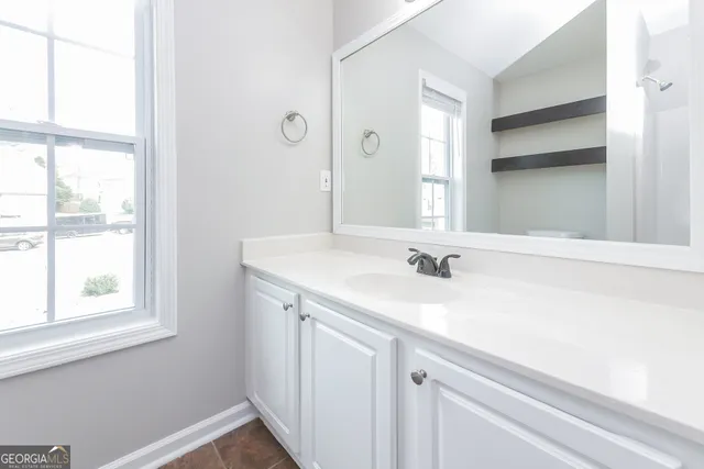 a bathroom with a sink a vanity and a mirror