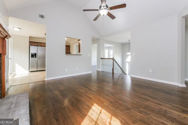 a view of a room with wooden floor and staircase