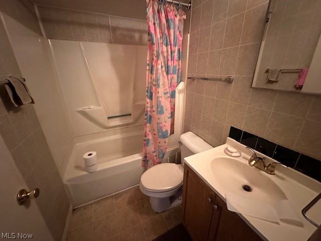 7701 Dercum Road Cleveland, OH 44105 - Photo 13 of 23 Full bathroom with tile walls, toilet, tile floors, shower / bath combination with curtain, and large vanity