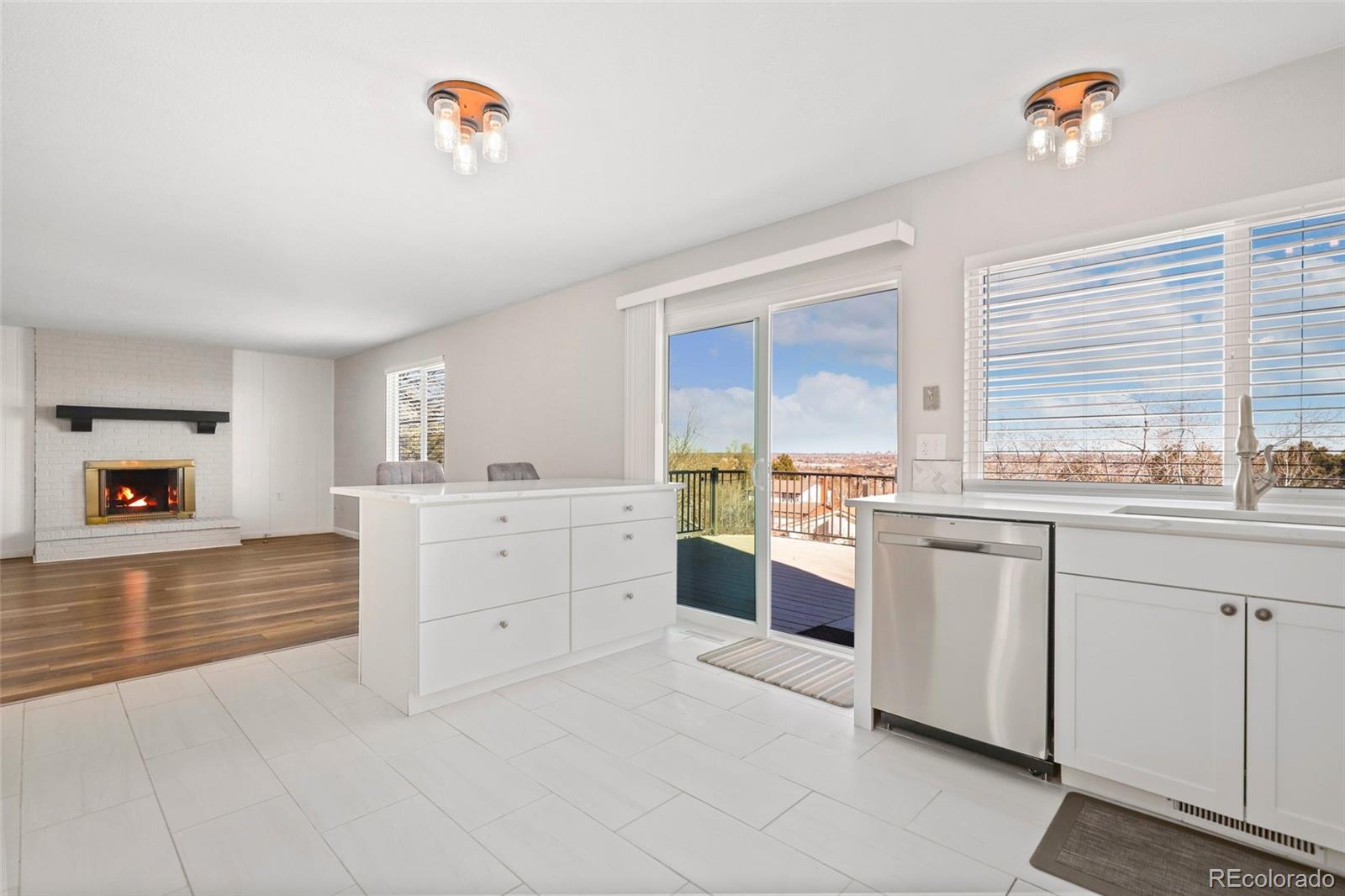 5484 South Cimarron Road Littleton, CO 80123 - Photo 15 of 40 a kitchen with white cabinets and a stove