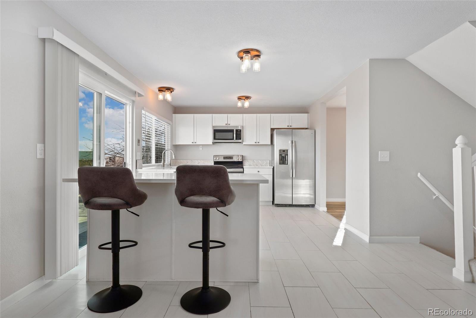 5484 South Cimarron Road Littleton, CO 80123 - Photo 17 of 40 a kitchen with furniture and a chandelier