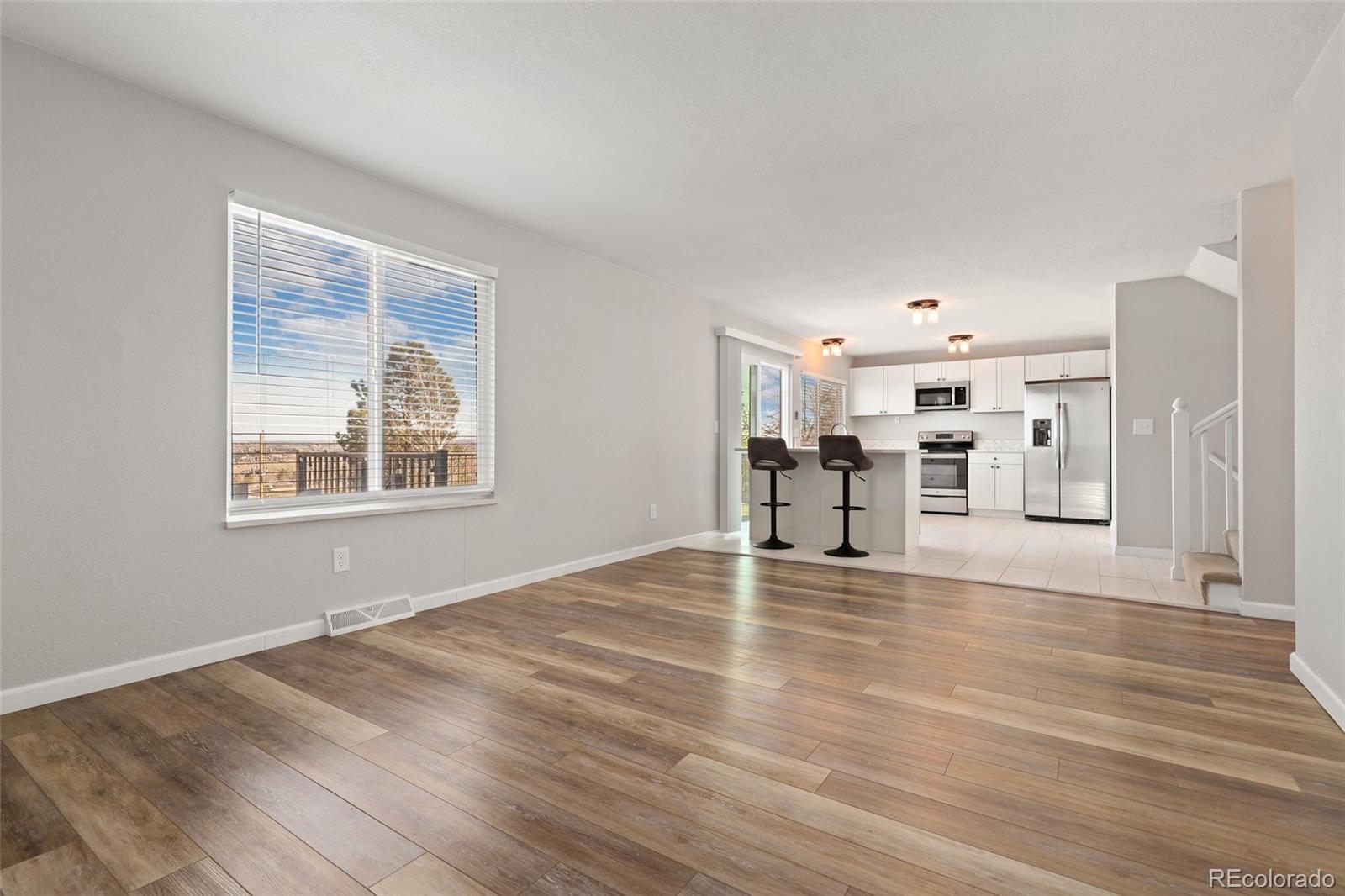 5484 South Cimarron Road Littleton, CO 80123 - Photo 19 of 40 a view of a livingroom with wooden floor