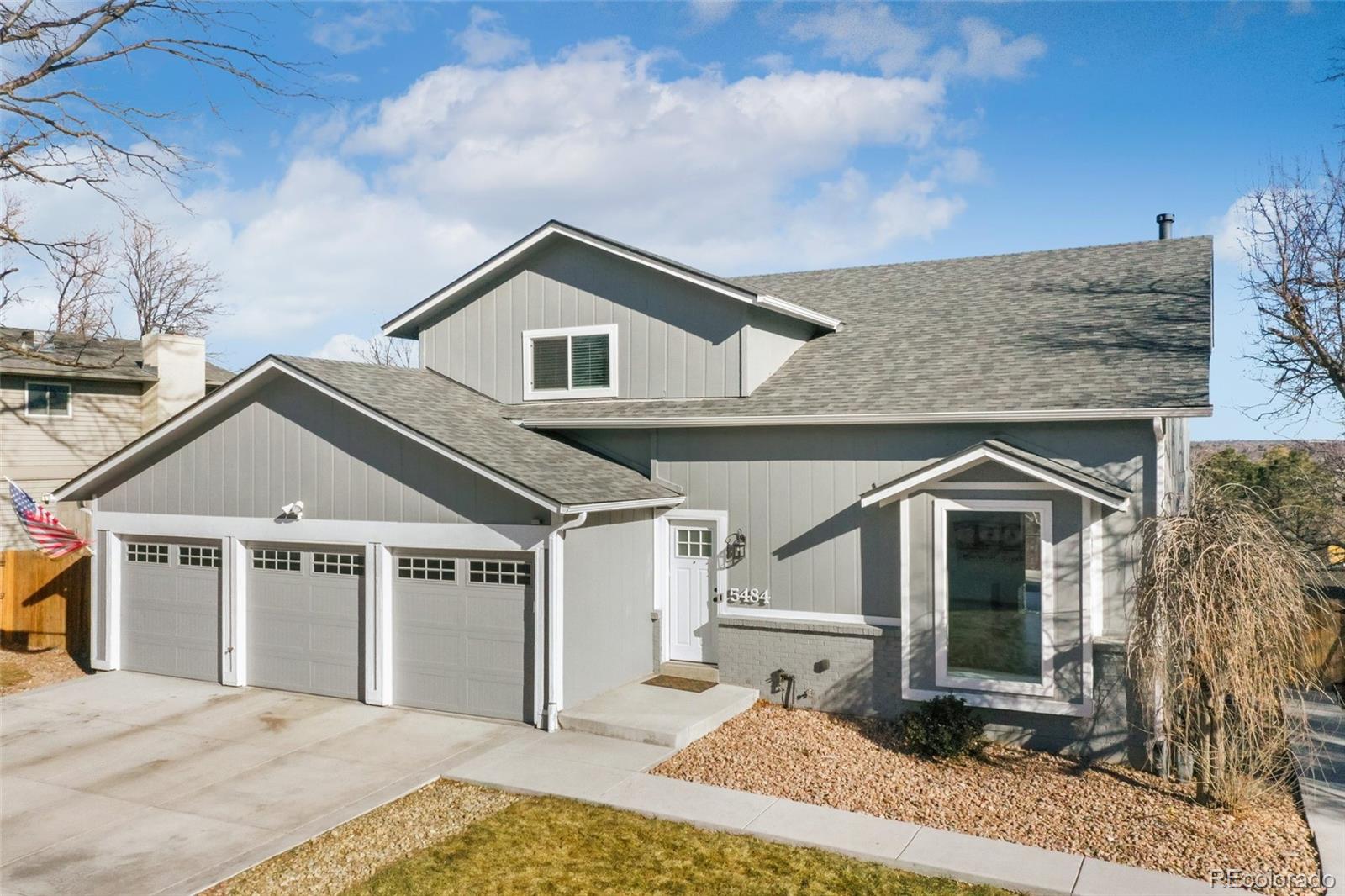 5484 South Cimarron Road Littleton, CO 80123 - Photo 2 of 40 a front view of a house with garden