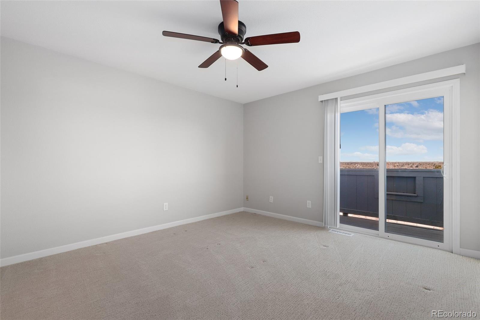 5484 South Cimarron Road Littleton, CO 80123 - Photo 22 of 40 an empty room with closet and a chandelier fan