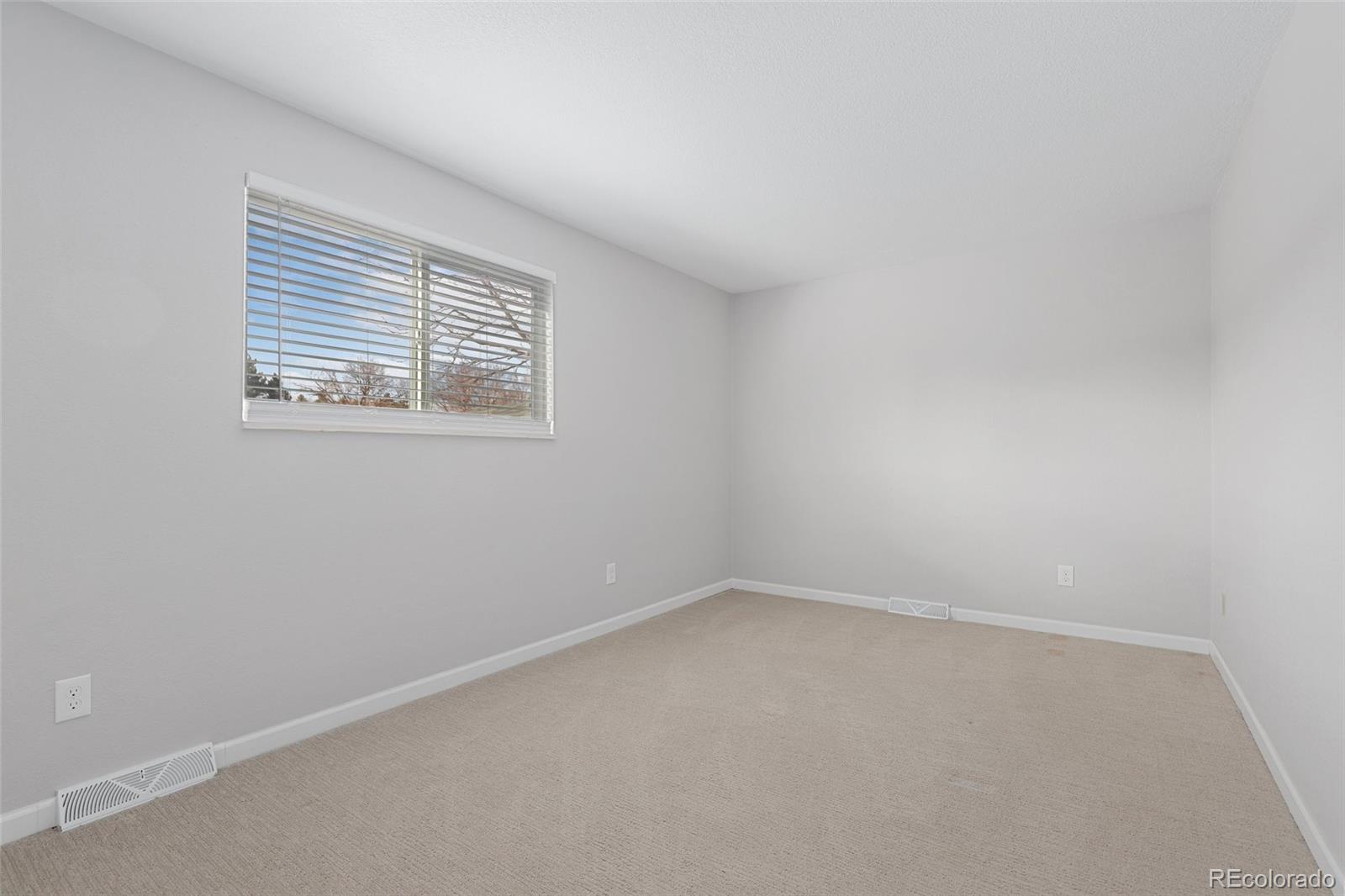 5484 South Cimarron Road Littleton, CO 80123 - Photo 26 of 40 an empty room with a window