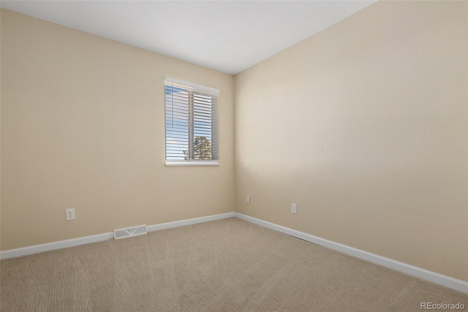 5484 South Cimarron Road Littleton, CO 80123 - Photo 28 of 40 an empty room with a window
