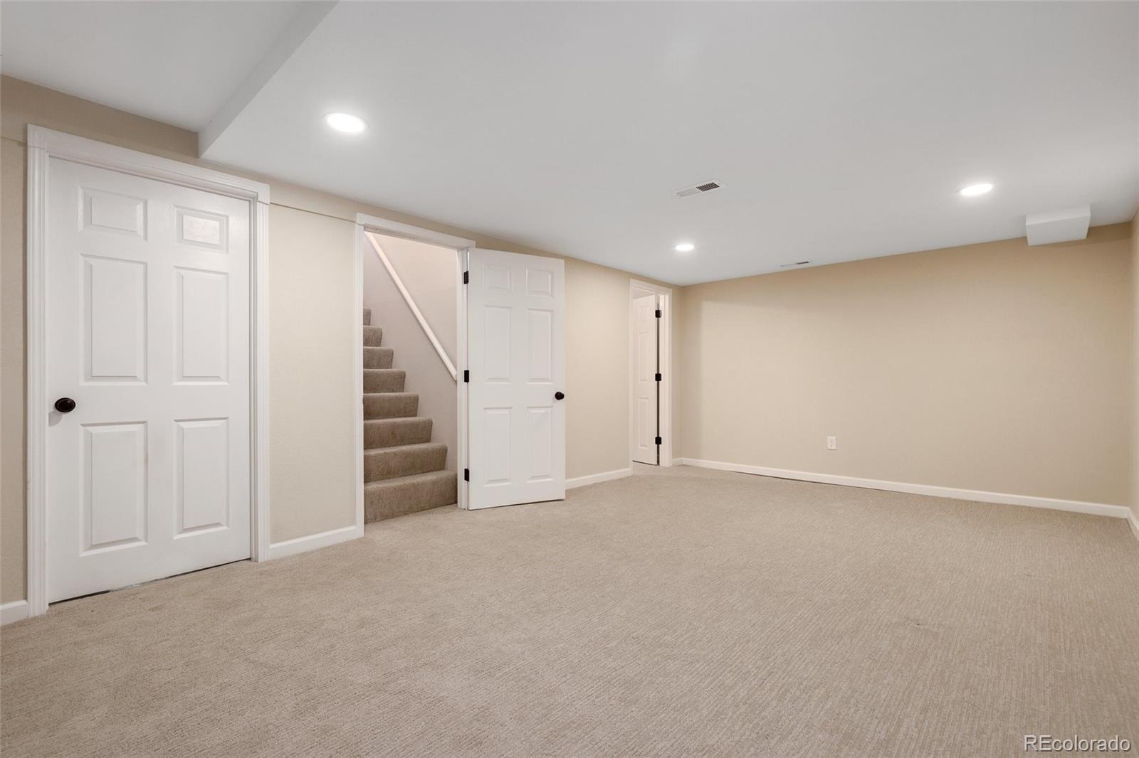 5484 South Cimarron Road Littleton, CO 80123 - Photo 32 of 40 an empty room with a ceiling fan and entryway