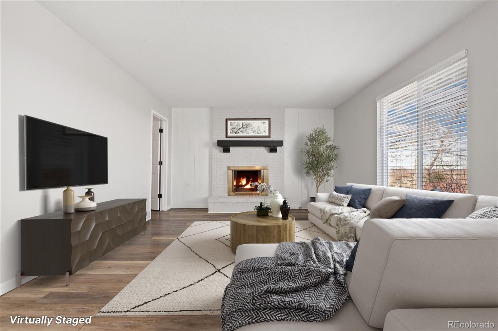 5484 South Cimarron Road Littleton, CO 80123 - Photo 5 of 40 a living room with furniture and a flat screen tv