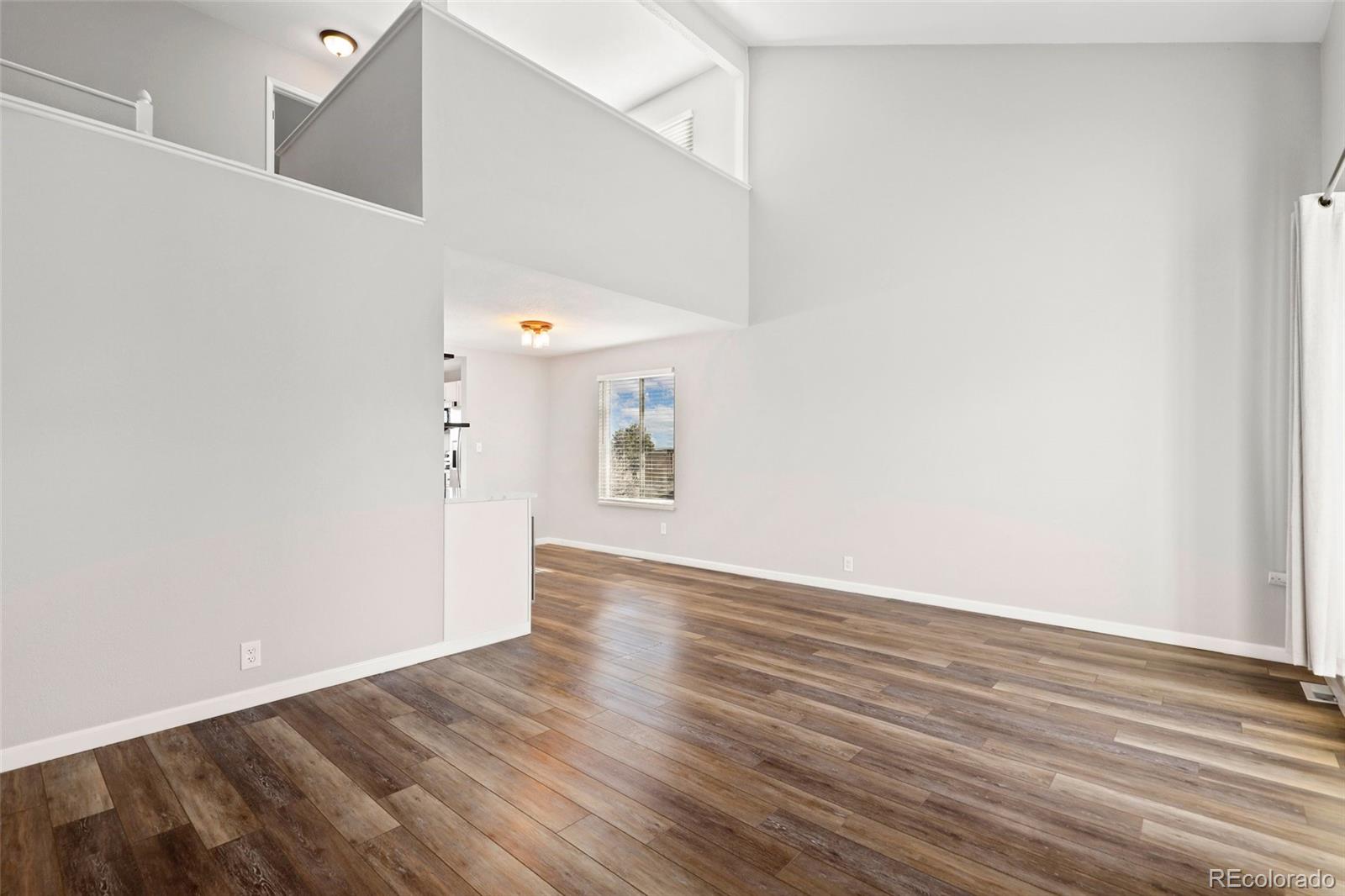 5484 South Cimarron Road Littleton, CO 80123 - Photo 8 of 40 a view of an empty room with wooden floor