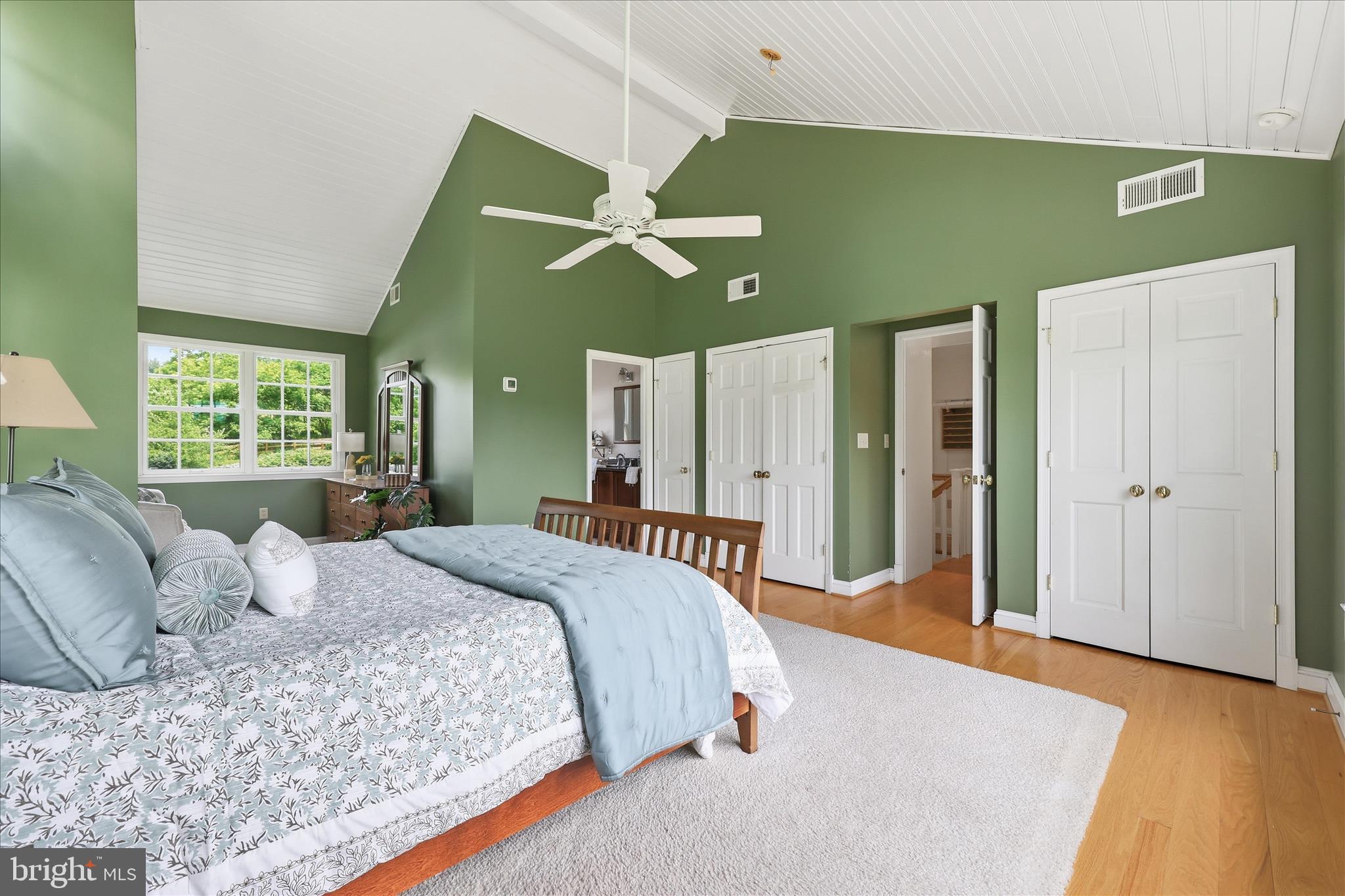 10919 Etzler Mill Road Woodsboro, MD 21798 - Photo 23 of 54 a bedroom with a large bed a chandelier and a window