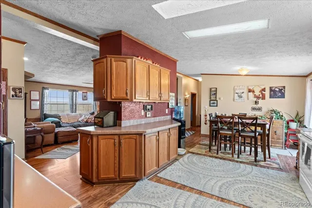 a dining hall with couches a coffee table and chairs with wooden floor