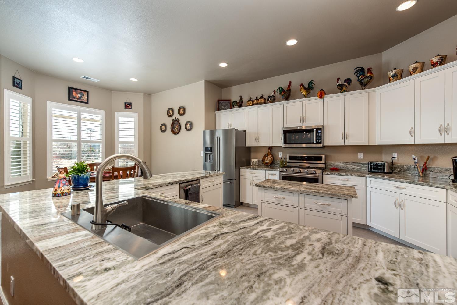 2603 Skyline Drive Minden, NV 89423 - Photo 13 of 40 a kitchen with stainless steel appliances granite countertop a sink dishwasher a stove and refrigerator with wooden floor