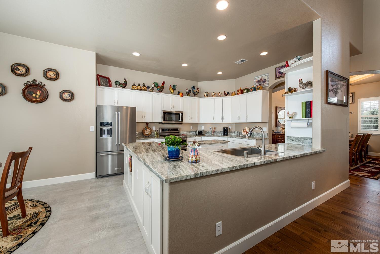 2603 Skyline Drive Minden, NV 89423 - Photo 15 of 40 a kitchen with stainless steel appliances granite countertop a sink refrigerator and cabinets