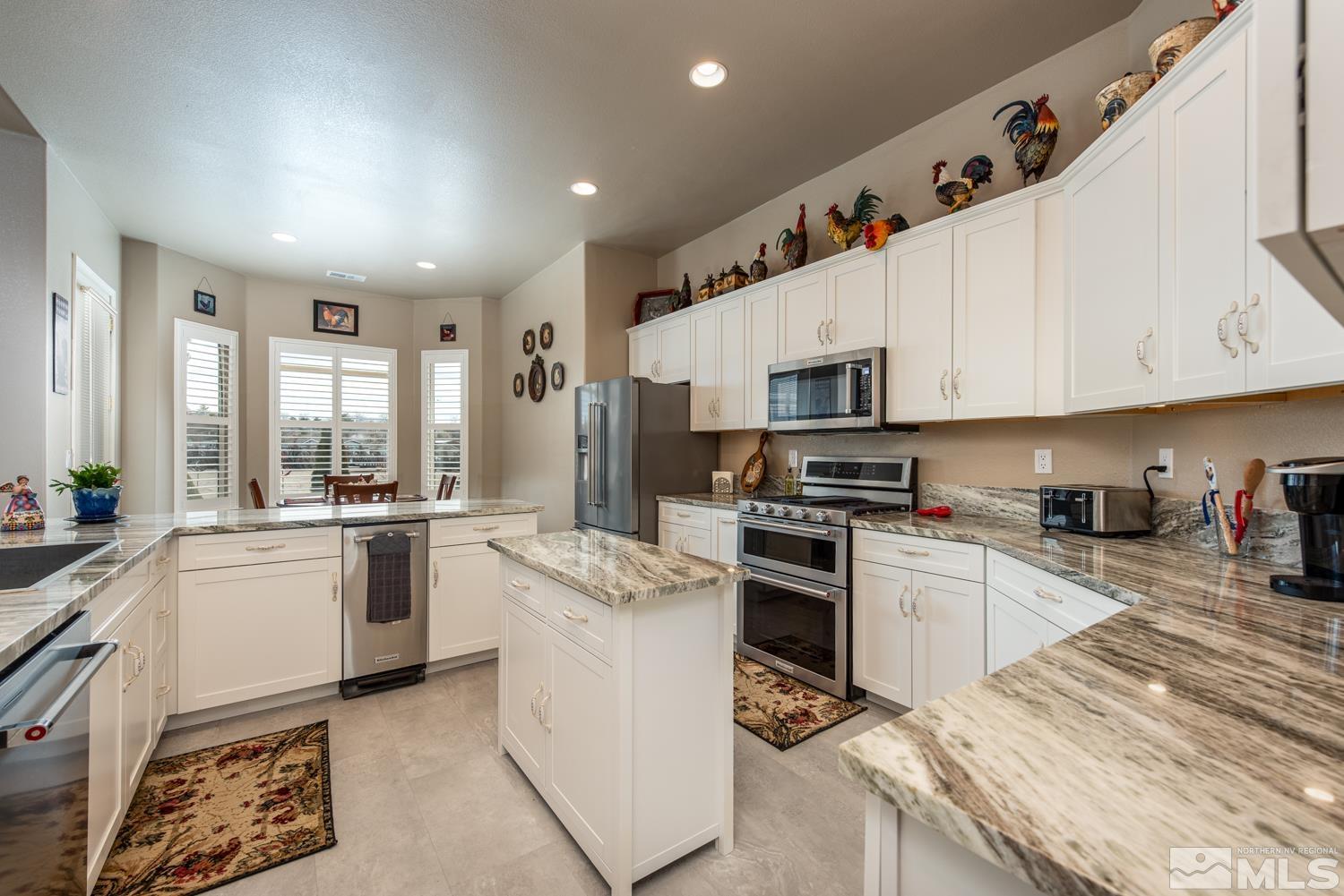 2603 Skyline Drive Minden, NV 89423 - Photo 16 of 40 a kitchen with granite countertop a sink stainless steel appliances and cabinets