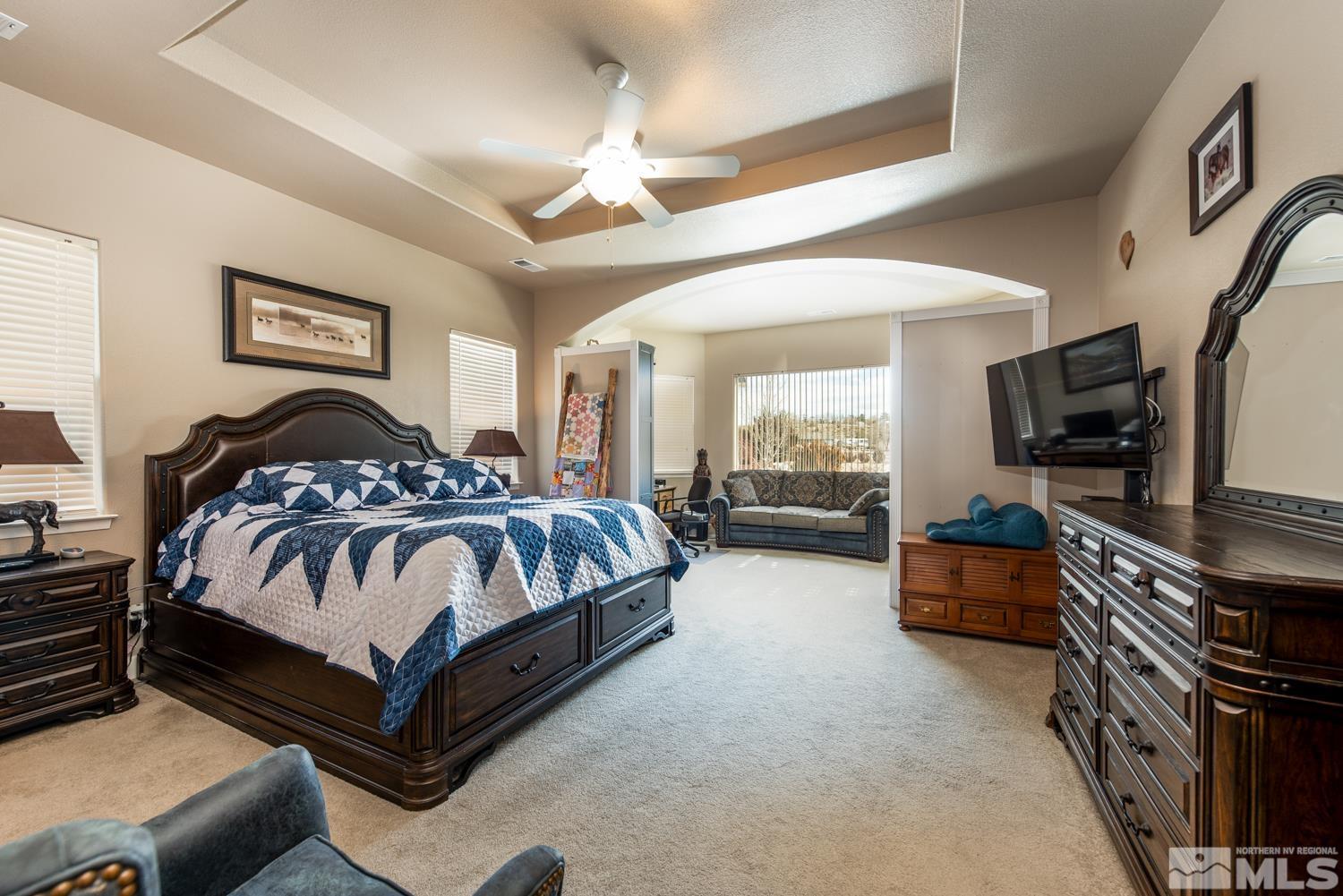2603 Skyline Drive Minden, NV 89423 - Photo 18 of 40 a spacious bedroom with a bed and a flat screen tv