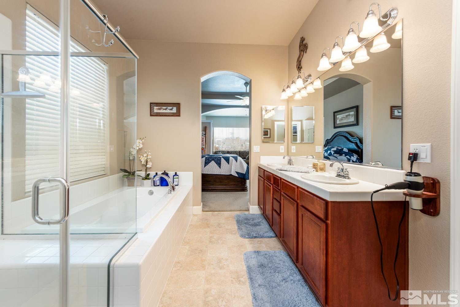 2603 Skyline Drive Minden, NV 89423 - Photo 23 of 40 a en suite spacious bathroom with a tub sink and mirror