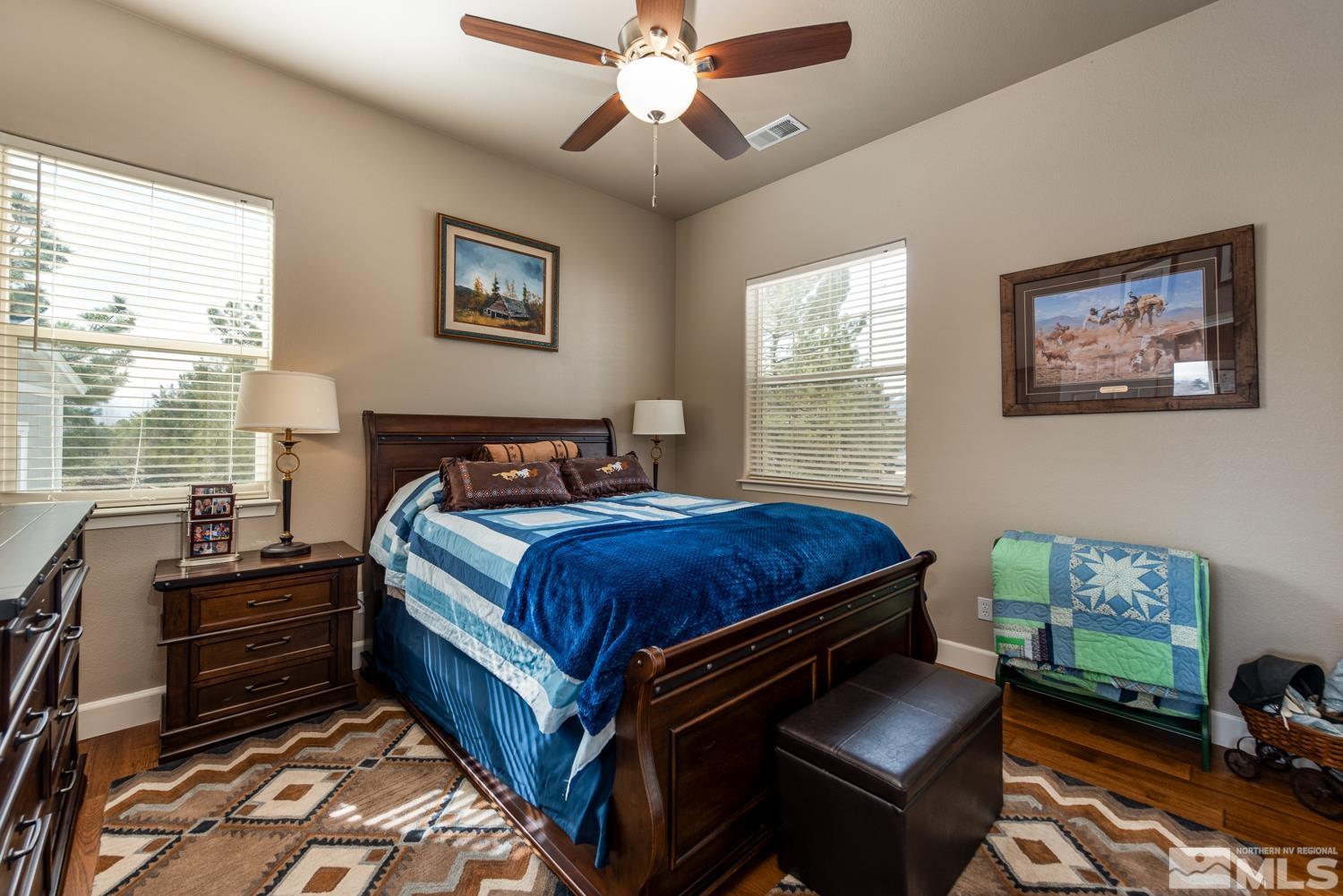 2603 Skyline Drive Minden, NV 89423 - Photo 24 of 40 a bedroom with a bed and a chandelier