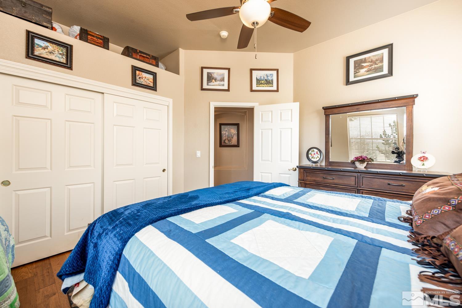 2603 Skyline Drive Minden, NV 89423 - Photo 25 of 40 a bedroom with a bed and a chandelier