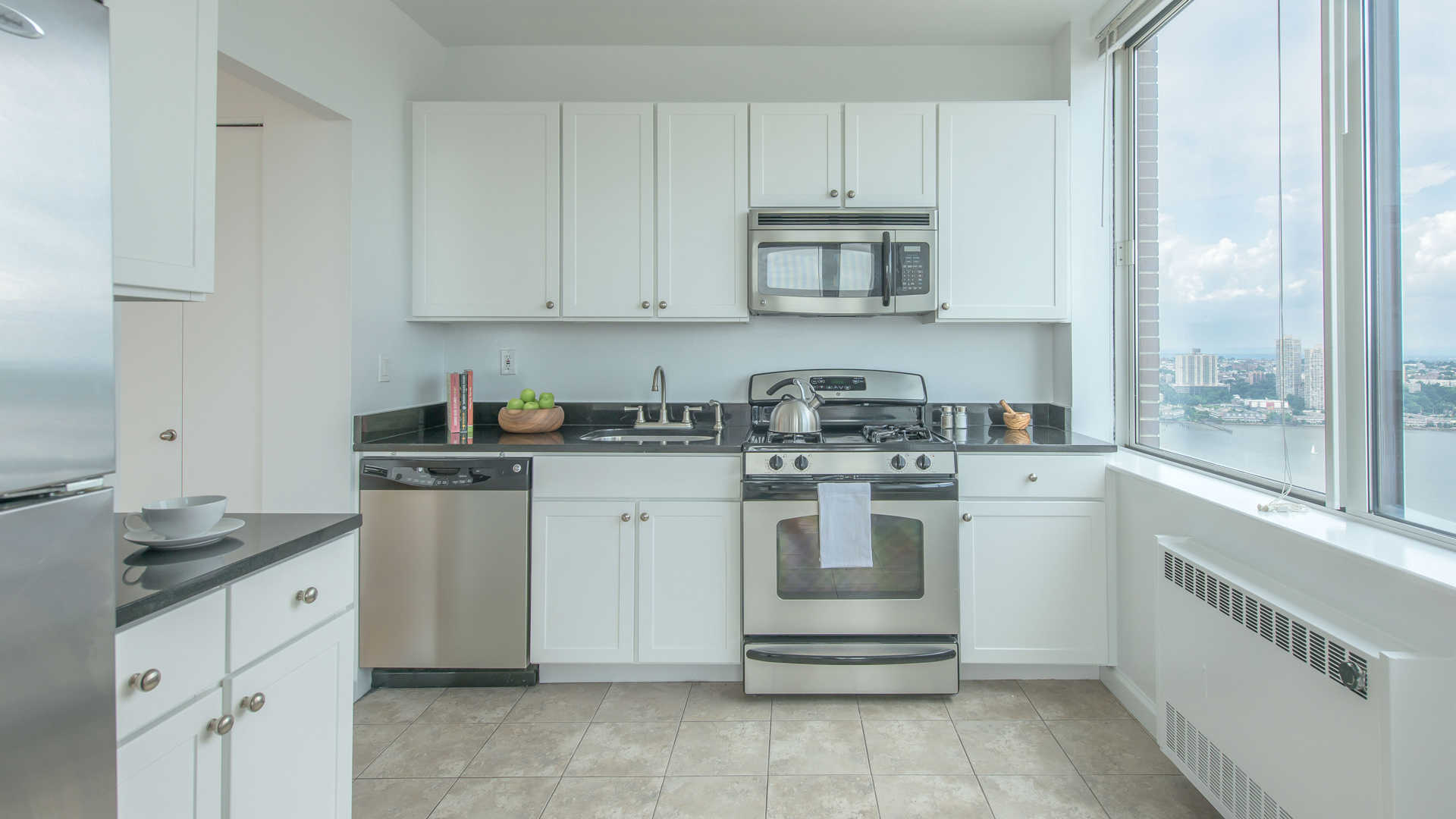 a kitchen with white cabinets and white appliances