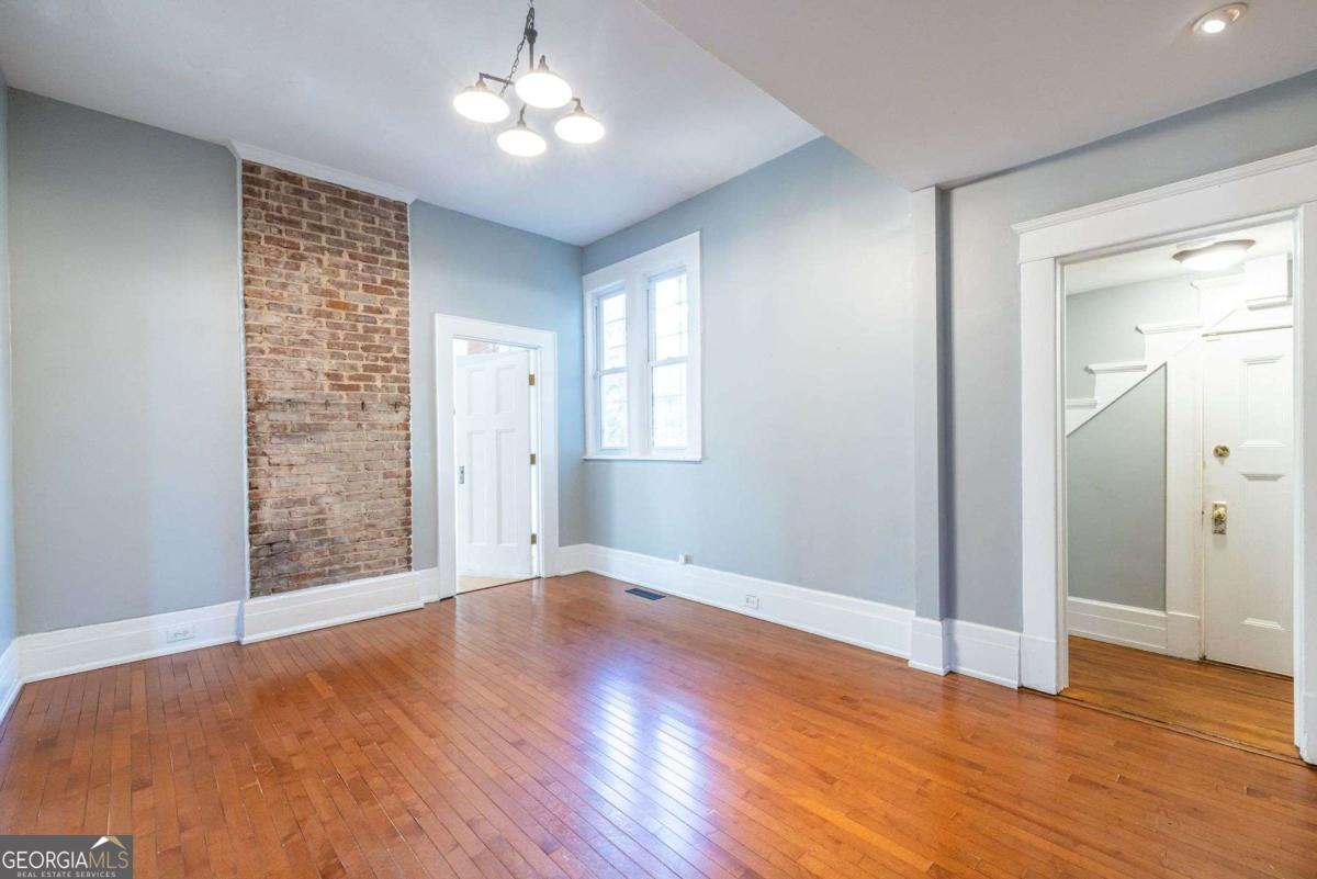692 Myrtle Street Northeast Atlanta, GA 30308 - Photo 25 of 73 a view of an empty room with wooden floor and a window