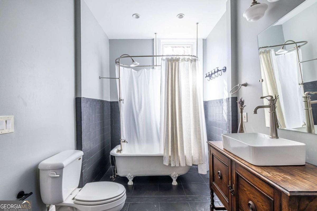 692 Myrtle Street Northeast Atlanta, GA 30308 - Photo 27 of 73 a bathroom with a sink a toilet and a mirror