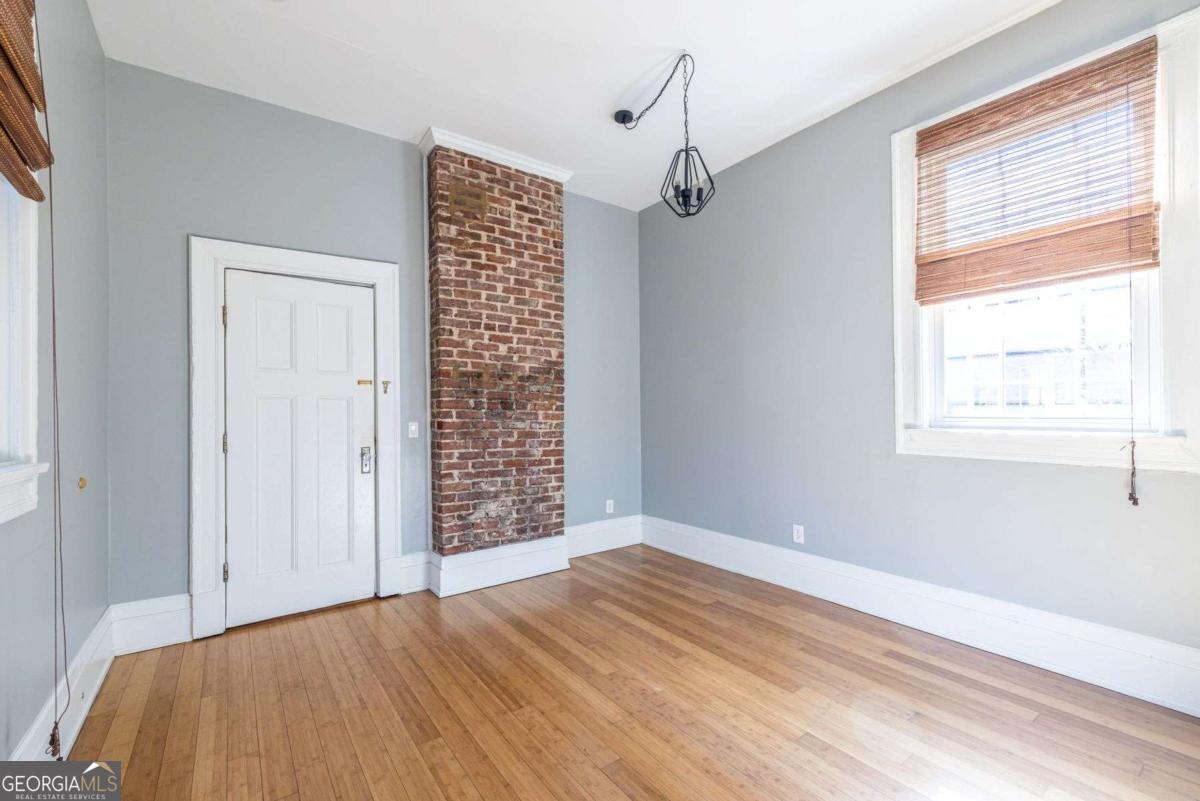 692 Myrtle Street Northeast Atlanta, GA 30308 - Photo 29 of 73 a view of empty room with wooden floor and fan