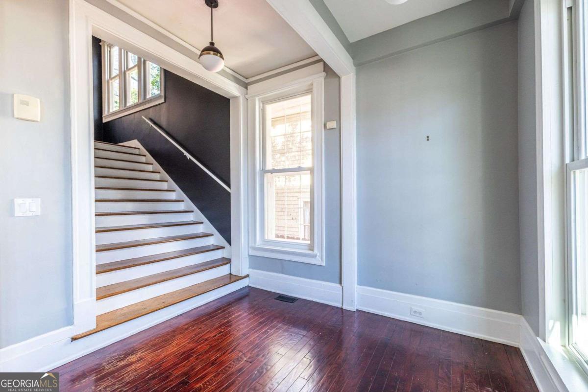 692 Myrtle Street Northeast Atlanta, GA 30308 - Photo 35 of 73 a view of a livingroom with wooden floor and stairs