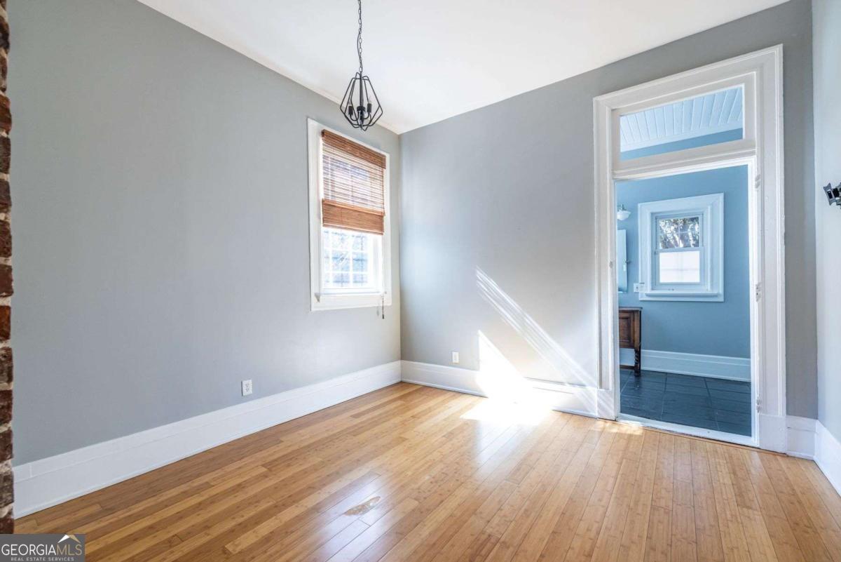 692 Myrtle Street Northeast Atlanta, GA 30308 - Photo 39 of 73 an empty room with wooden floor closet and windows