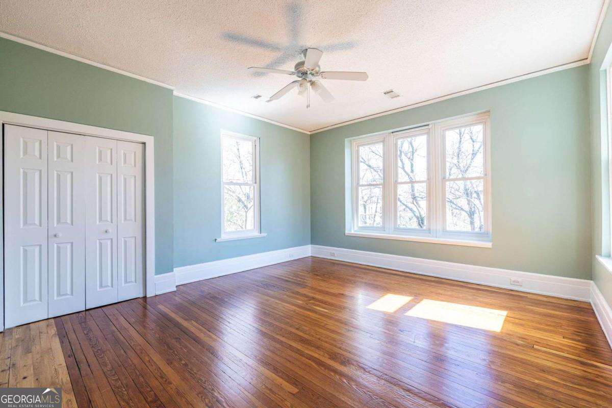 692 Myrtle Street Northeast Atlanta, GA 30308 - Photo 43 of 73 a view of an empty room with wooden floor and a window