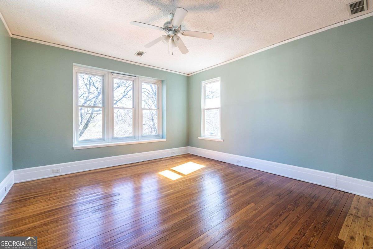 692 Myrtle Street Northeast Atlanta, GA 30308 - Photo 44 of 73 a view of an empty room with wooden floor and a window
