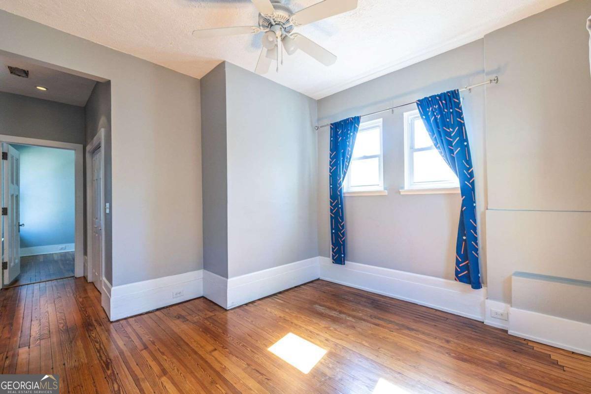 692 Myrtle Street Northeast Atlanta, GA 30308 - Photo 46 of 73 a view of empty room with wooden floor and fan