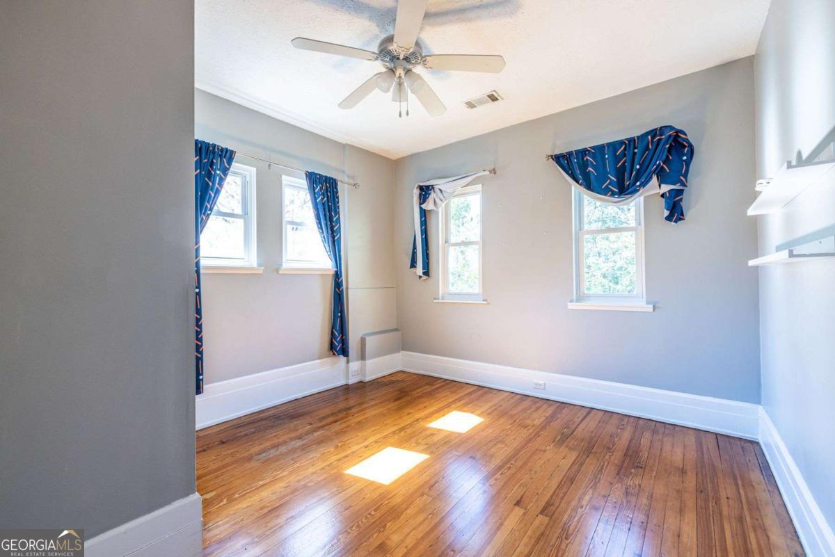 692 Myrtle Street Northeast Atlanta, GA 30308 - Photo 47 of 73 an empty room with windows and fan