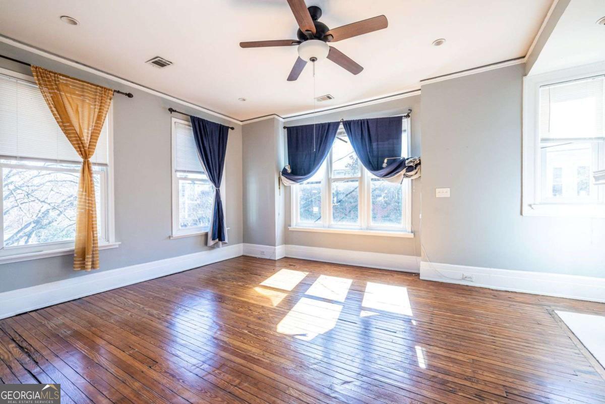 692 Myrtle Street Northeast Atlanta, GA 30308 - Photo 50 of 73 a view of an empty room with wooden floor and a window