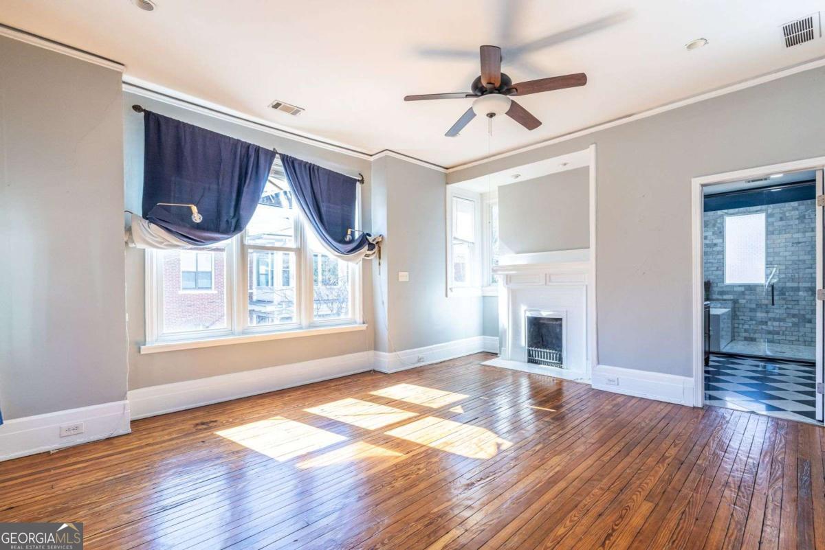 692 Myrtle Street Northeast Atlanta, GA 30308 - Photo 51 of 73 a view of empty room with wooden floor and fan