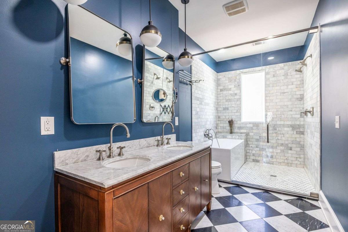 692 Myrtle Street Northeast Atlanta, GA 30308 - Photo 53 of 73 a bathroom with a sink a toilet and shower