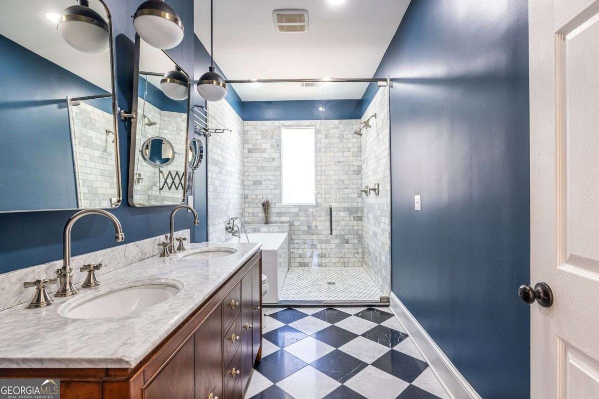 692 Myrtle Street Northeast Atlanta, GA 30308 - Photo 54 of 73 a bathroom with a granite countertop sink a mirror and shower