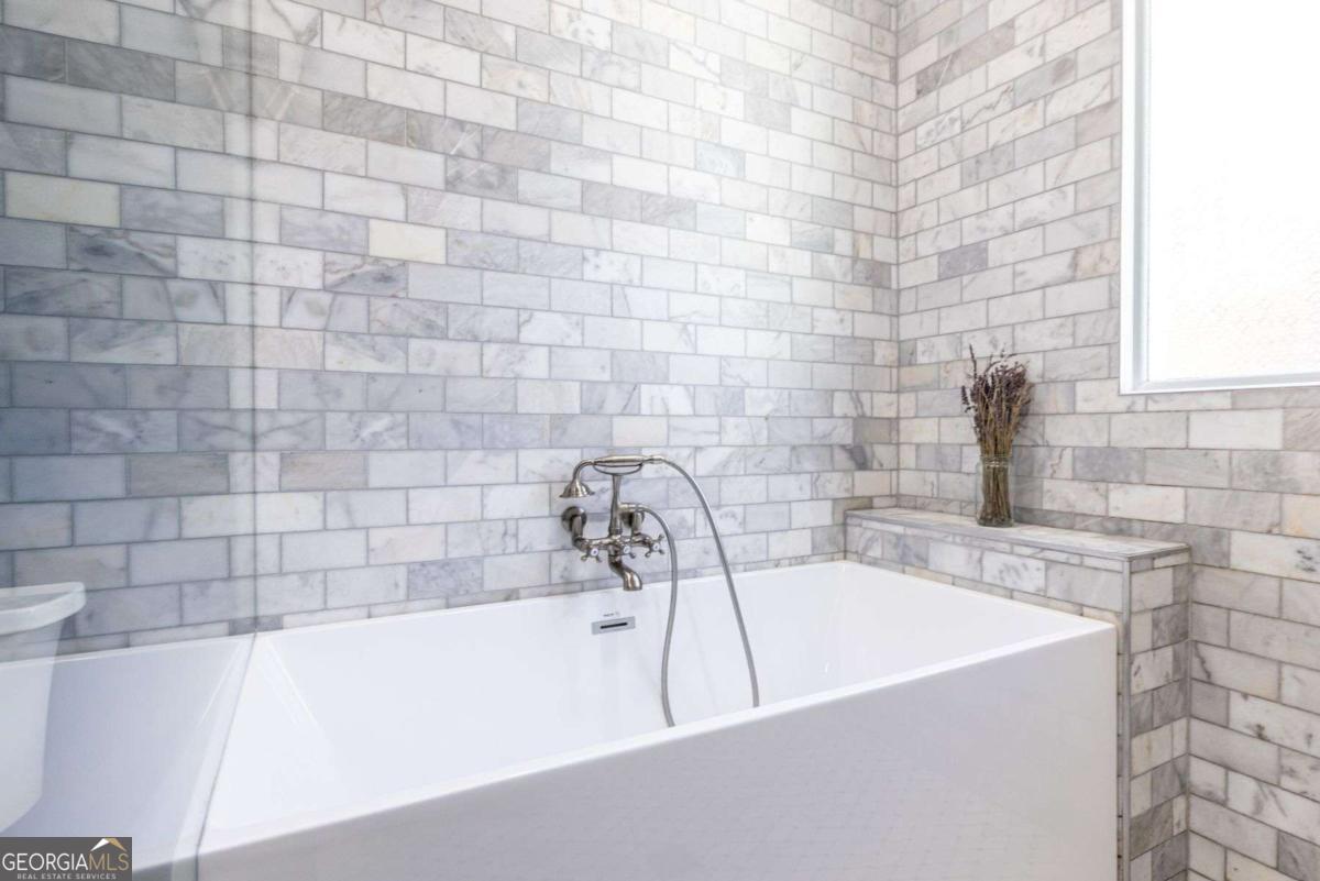 692 Myrtle Street Northeast Atlanta, GA 30308 - Photo 56 of 73 a bathroom with a sink and a bathtub