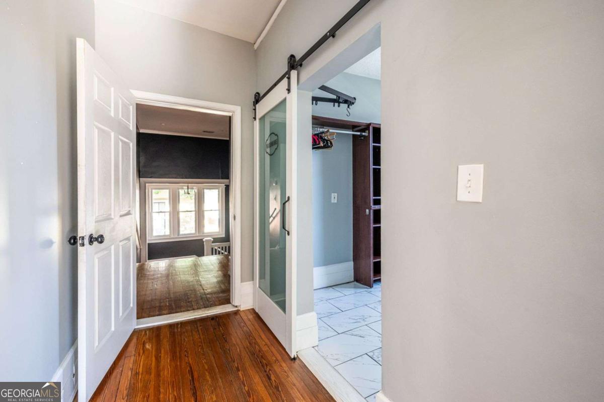 692 Myrtle Street Northeast Atlanta, GA 30308 - Photo 59 of 73 a view of a hallway with wooden floor and staircase
