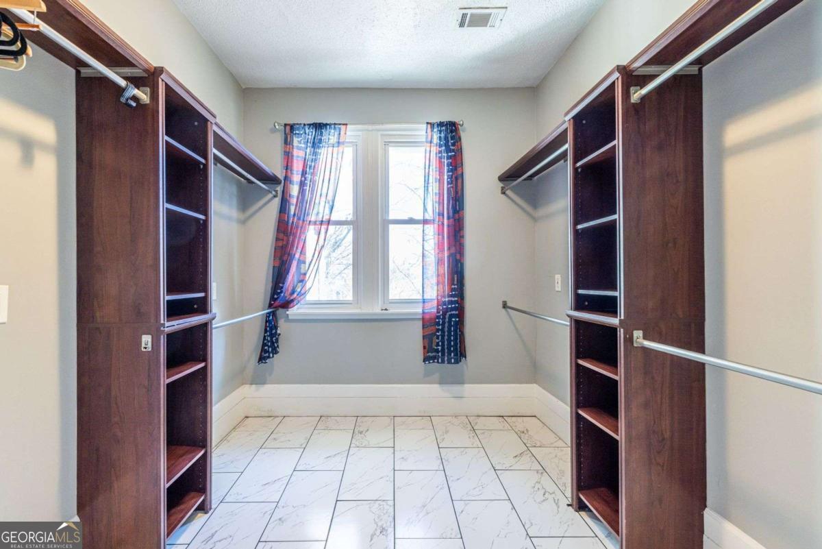 692 Myrtle Street Northeast Atlanta, GA 30308 - Photo 60 of 73 a view of walk in closet with empty racks
