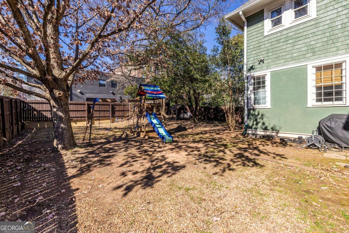 692 Myrtle Street Northeast Atlanta, GA 30308 - Photo 68 of 73 a view of a backyard with a table and chairs