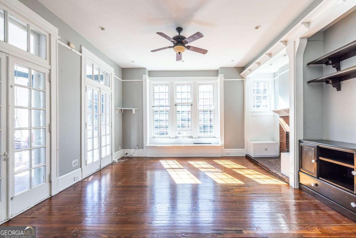 692 Myrtle Street Northeast Atlanta, GA 30308 - Photo 9 of 73 a view of an empty room with a window and wooden floor