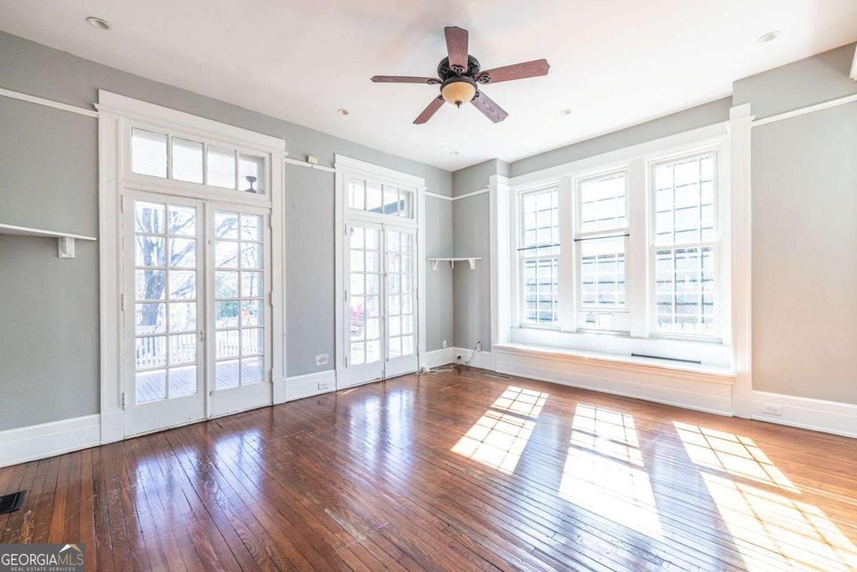 692 Myrtle Street Northeast Atlanta, GA 30308 - Photo 10 of 73 a view of an empty room with wooden floor and a window