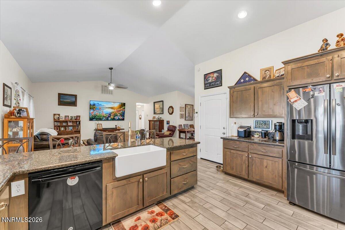 1197 Sky Ridge Drive Fallon, NV 89406 - Photo 15 of 79 a kitchen with stainless steel appliances granite countertop a sink stove and refrigerator
